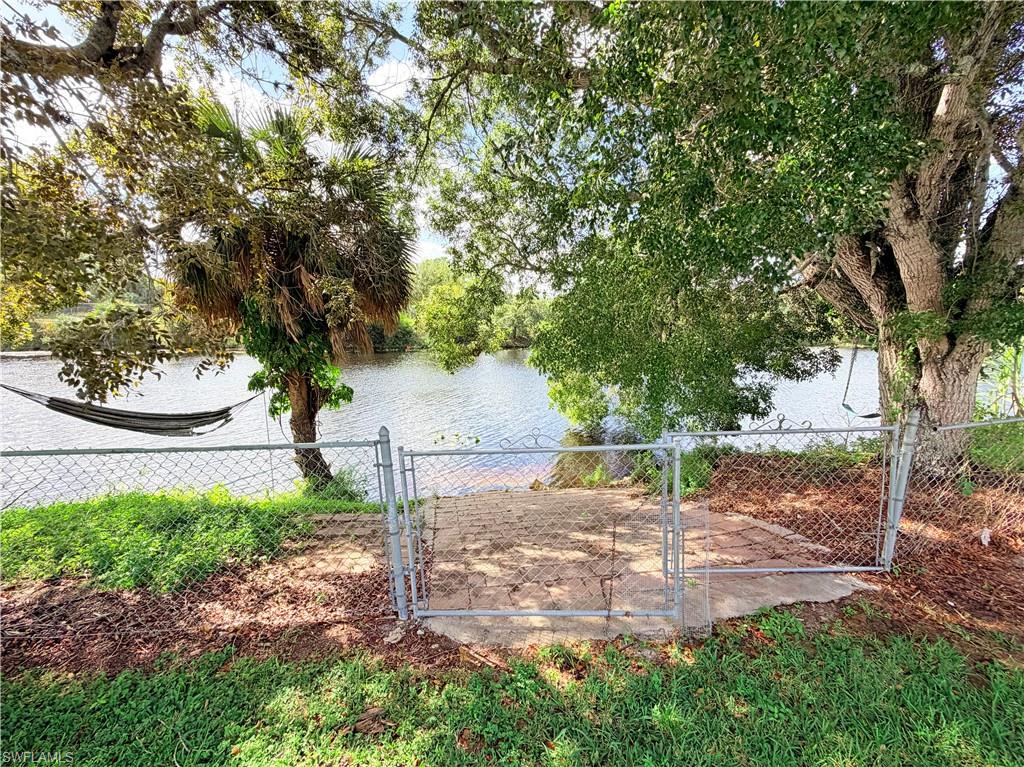 4212 32nd Avenue Southwest Naples, FL 34116 - Photo 24 of 27 a view of a yard with plants and a tree