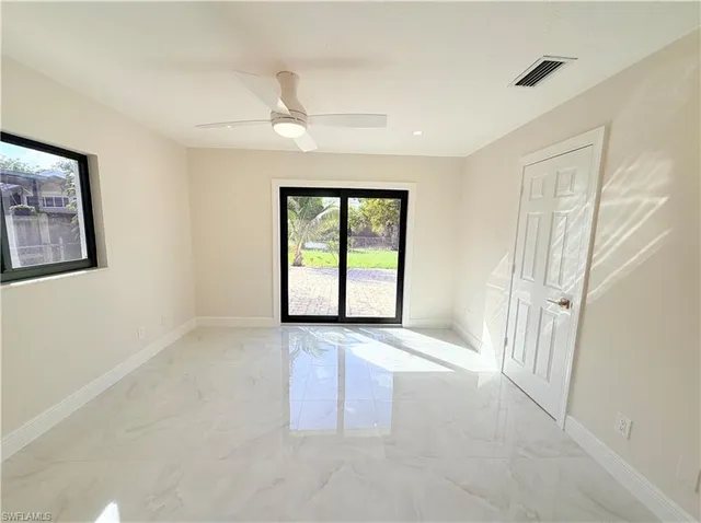 a view of kitchen with kitchen island stainless steel appliances refrigerator stove microwave and cabinets