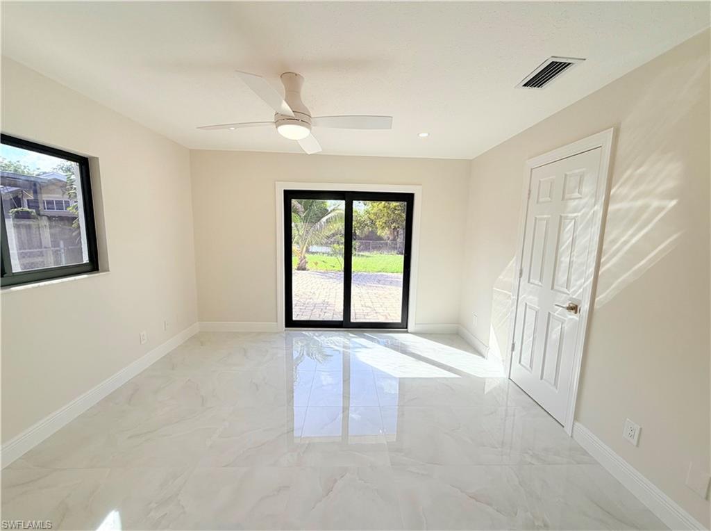 4212 32nd Avenue Southwest Naples, FL 34116 - Photo 4 of 27 an empty room with windows and closet