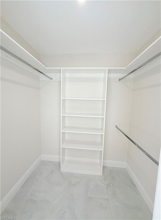 4212 32nd Avenue Southwest Naples, FL 34116 - Photo 5 of 27 a view of walk in closet with empty racks