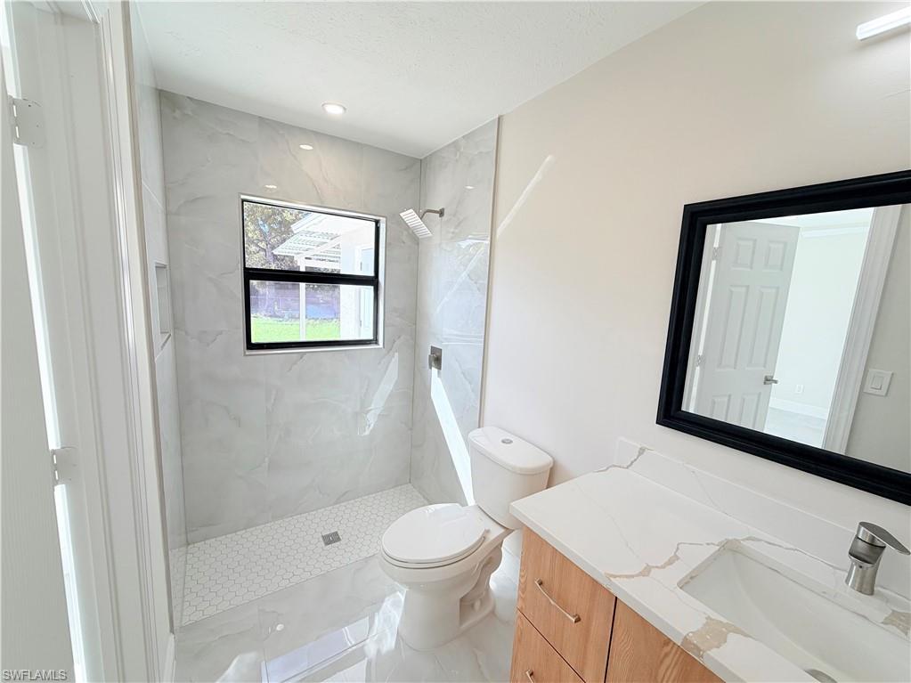 4212 32nd Avenue Southwest Naples, FL 34116 - Photo 6 of 27 a bathroom with a sink a toilet and shower
