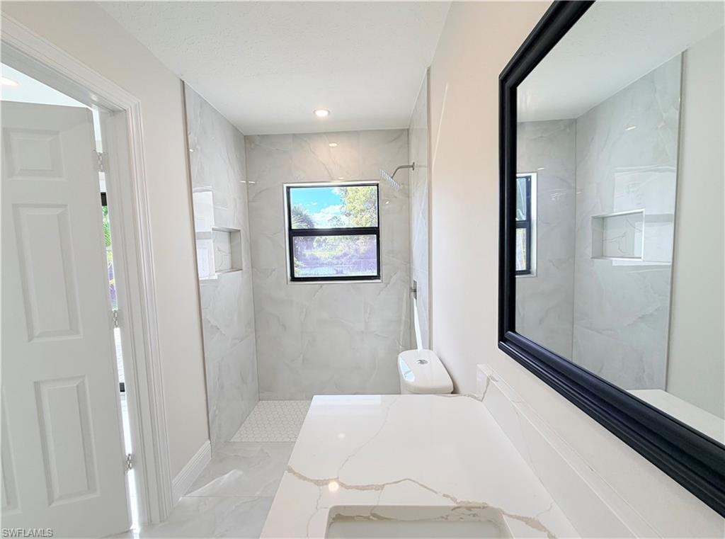4212 32nd Avenue Southwest Naples, FL 34116 - Photo 7 of 27 a bathroom with a bathtub and shower