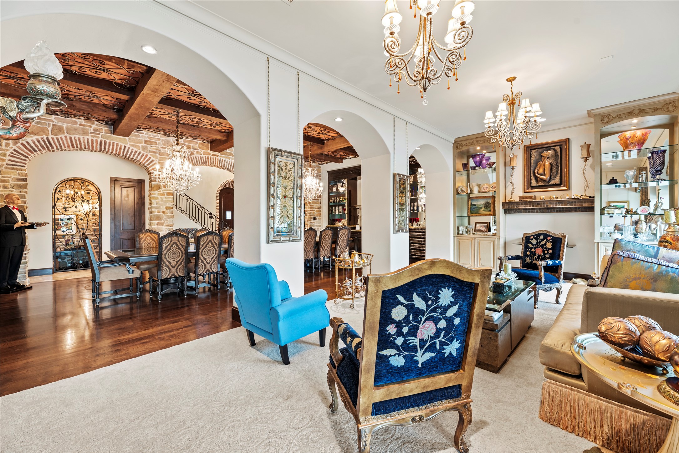 7715 Firethorne Creek Court Spring, TX 77389 - Photo 12 of 50 a living room with furniture a rug and a chandelier