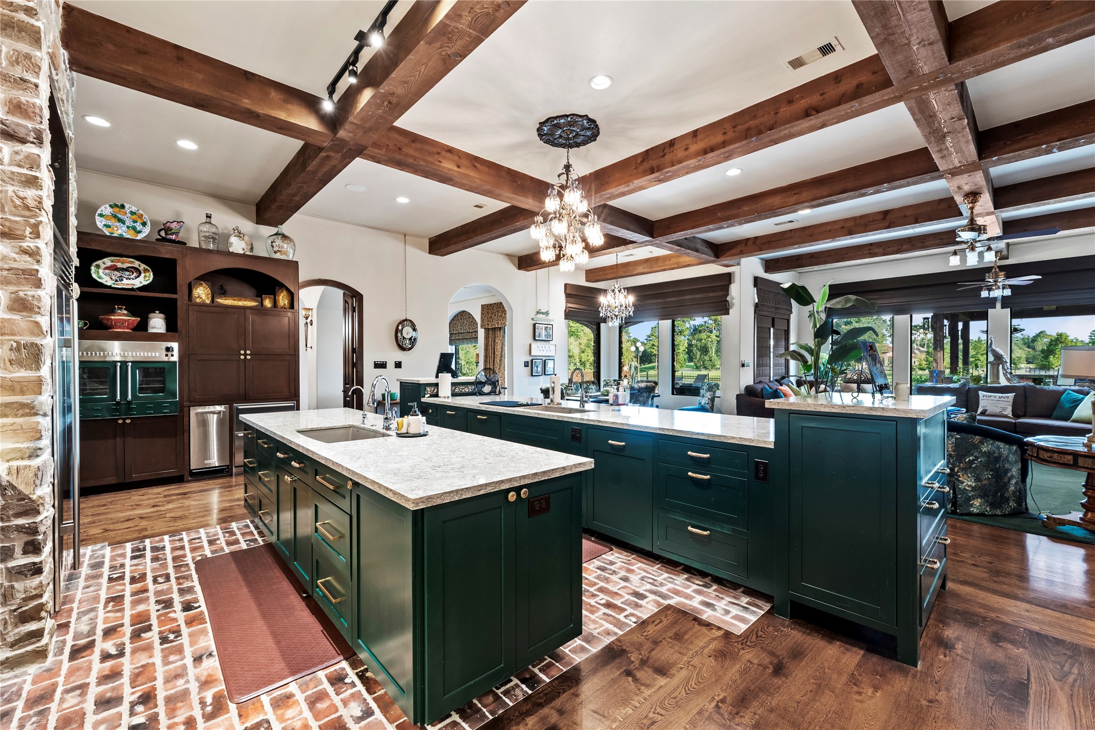 7715 Firethorne Creek Court Spring, TX 77389 - Photo 2 of 50 This gourmet kitchen boasts dual islands, a double sink, triple dishwashers, four ovens, a premium Wolf stove, Sub-Zero fridge and freezer, and a pizza oven—perfect for culinary enthusiasts.