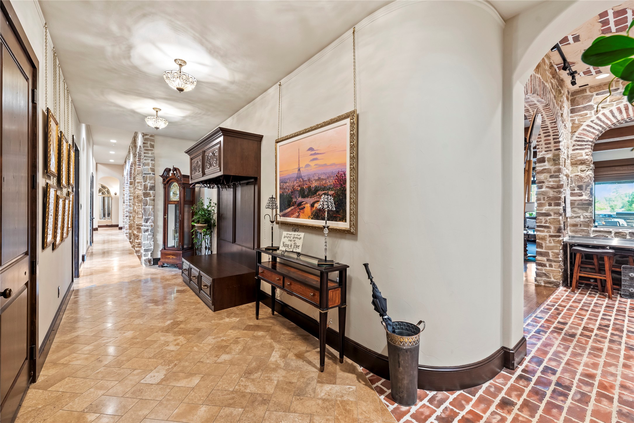 7715 Firethorne Creek Court Spring, TX 77389 - Photo 22 of 50 Elegant corridor featuring stylish lighting, rich wood accents, and beautiful stonework, seamlessly connecting living spaces with charm and sophistication.