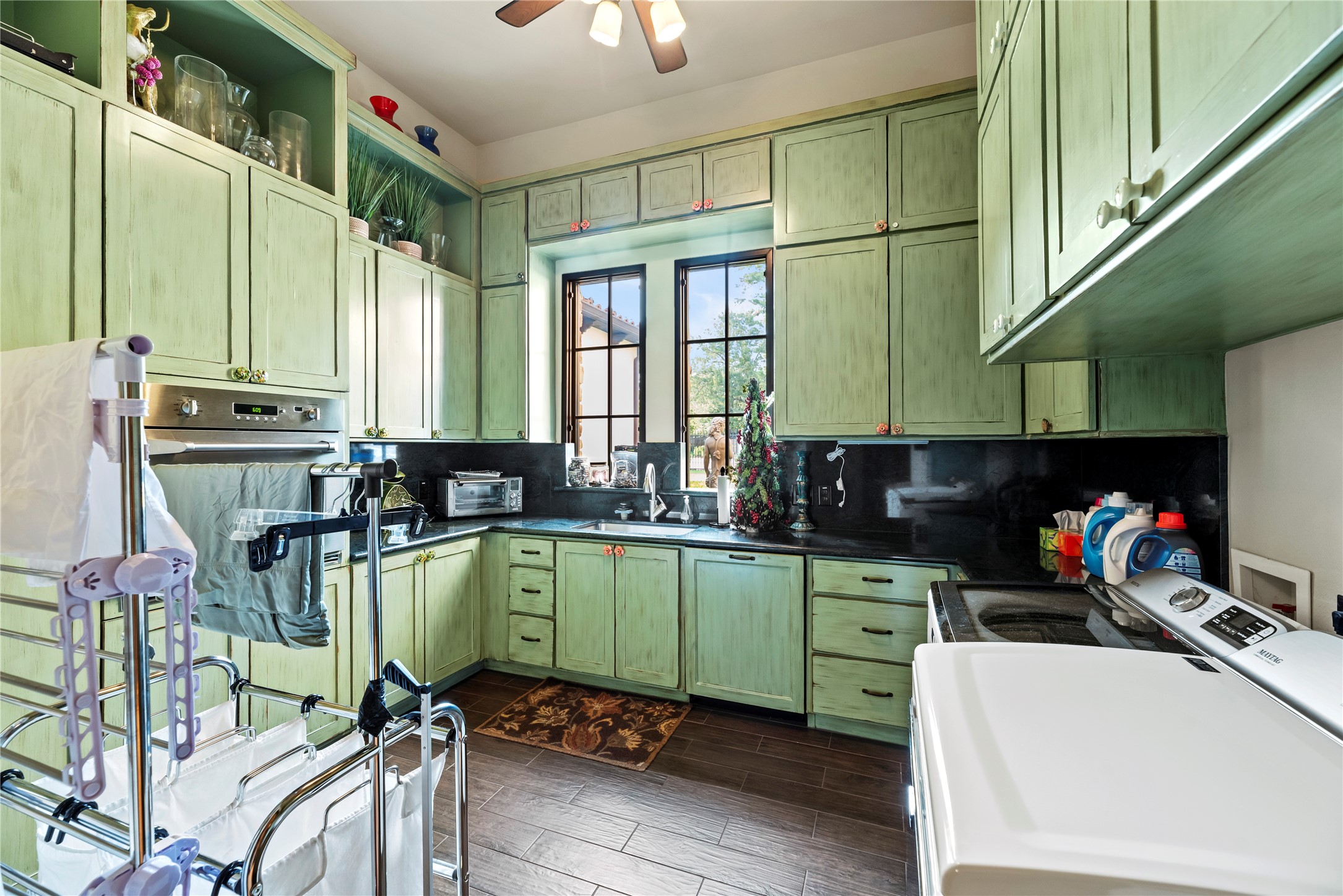 7715 Firethorne Creek Court Spring, TX 77389 - Photo 23 of 50 a kitchen with a sink a stove and a microwave