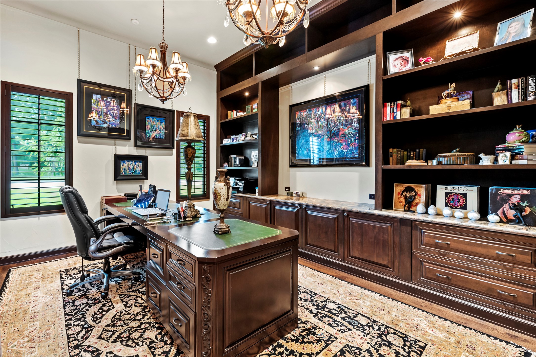 7715 Firethorne Creek Court Spring, TX 77389 - Photo 24 of 50 Elevate your workspace in this sophisticated home office featuring custom built-ins and elegant art niches.