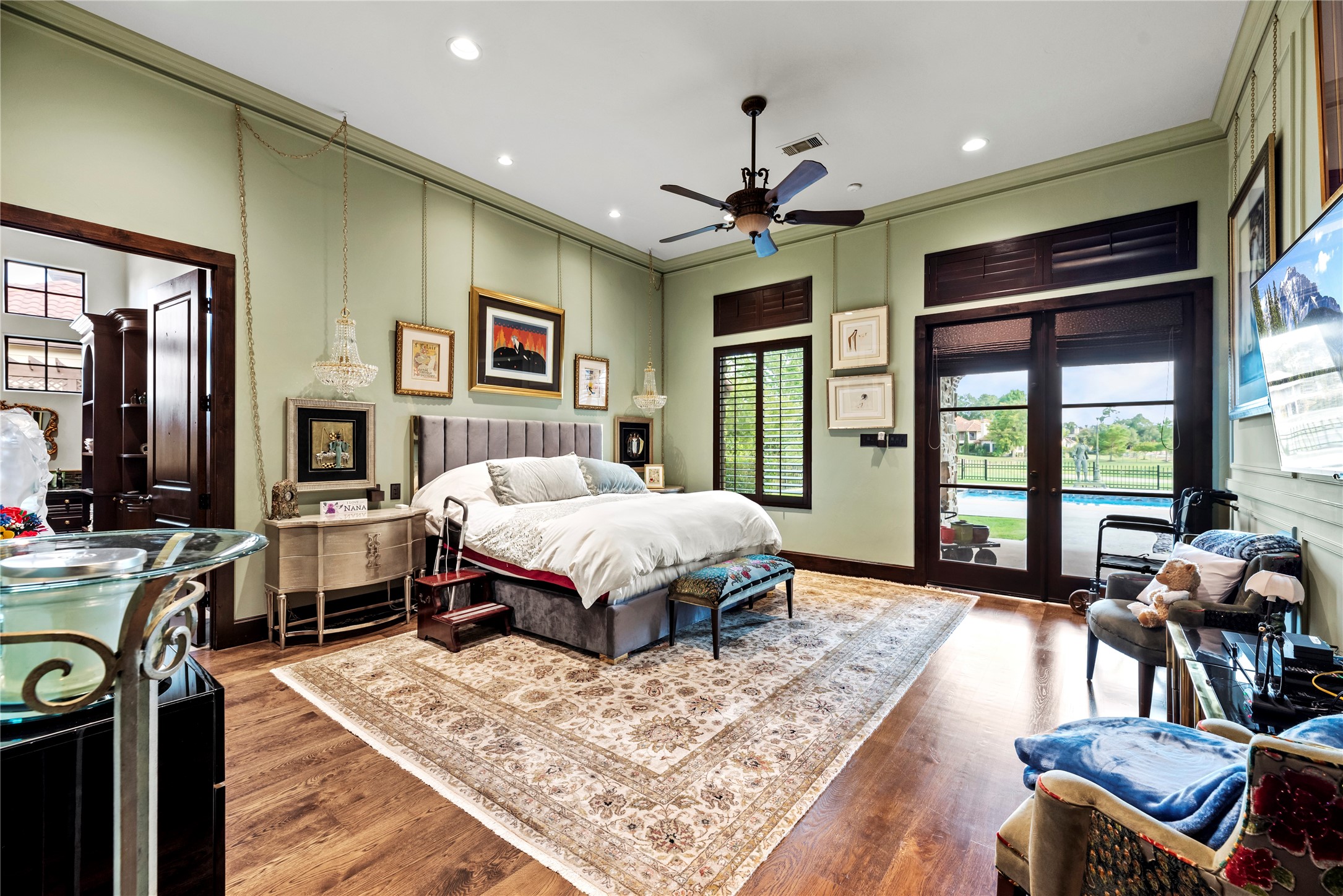 7715 Firethorne Creek Court Spring, TX 77389 - Photo 4 of 50 Luxurious primary suite with rich wood floors and private patio access.