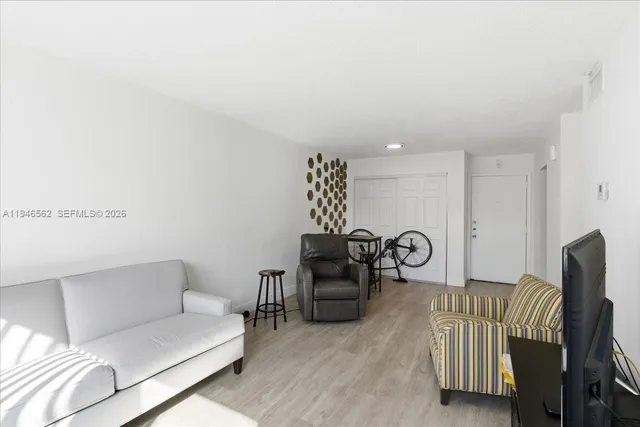 a living room with furniture a rug and a chandelier