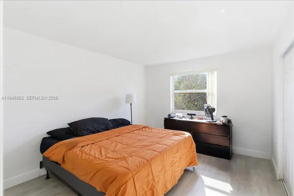 a bedroom with a bed and window