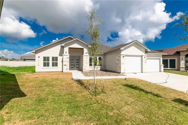 a view of a white house with a yard