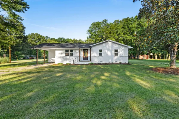 a front view of house with yard and green space