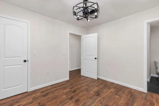 a view of a room with wooden floor