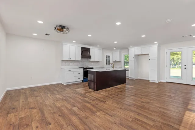 a large kitchen with kitchen island a sink stainless steel appliances and cabinets
