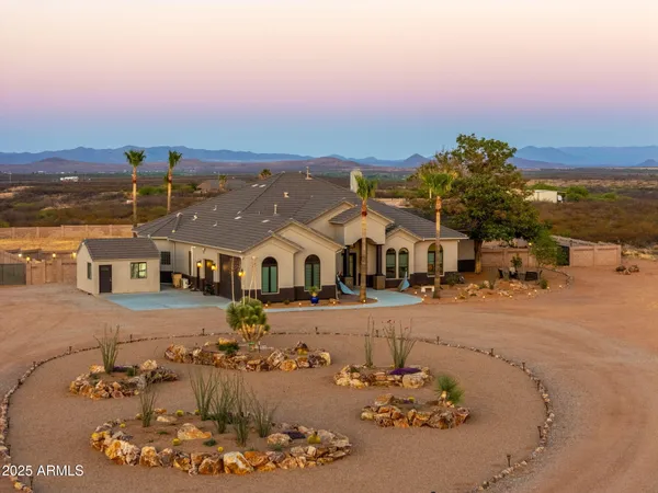 an aerial view of a house with a yard