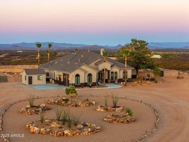 an aerial view of a house with a yard
