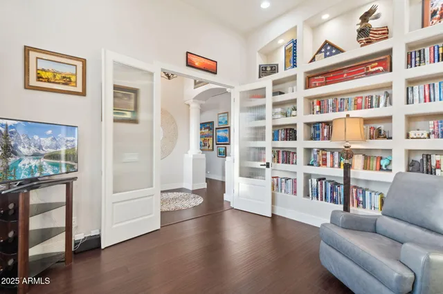 a living room with furniture and a book shelf