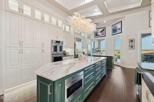 a large white kitchen with a large window