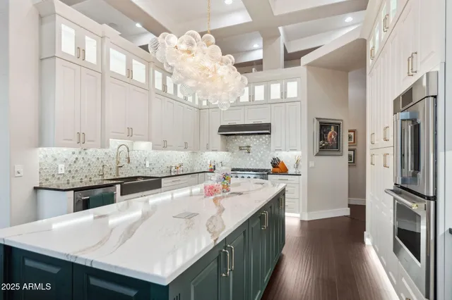 a kitchen with kitchen island a sink appliances and cabinets