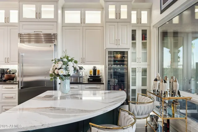 a dining room with furniture and large windows