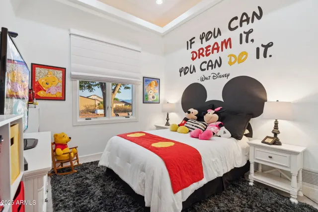 a bed room with a bed and a chandelier