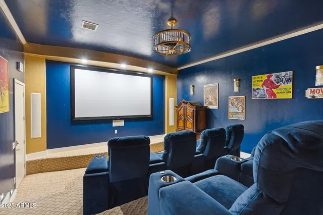 a media room with lots of chairs and a projector screen
