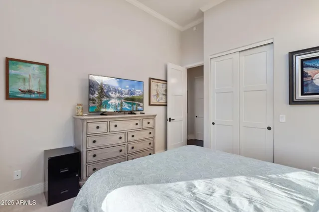 a bedroom with a bed and a dresser