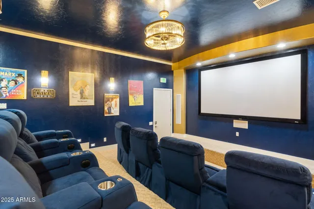 a room with furniture projector and screen