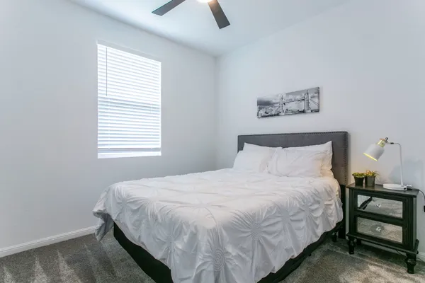 a view of a livingroom with a ceiling fan and window