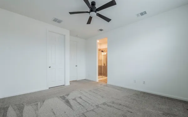 a view of a livingroom with a ceiling fan and window