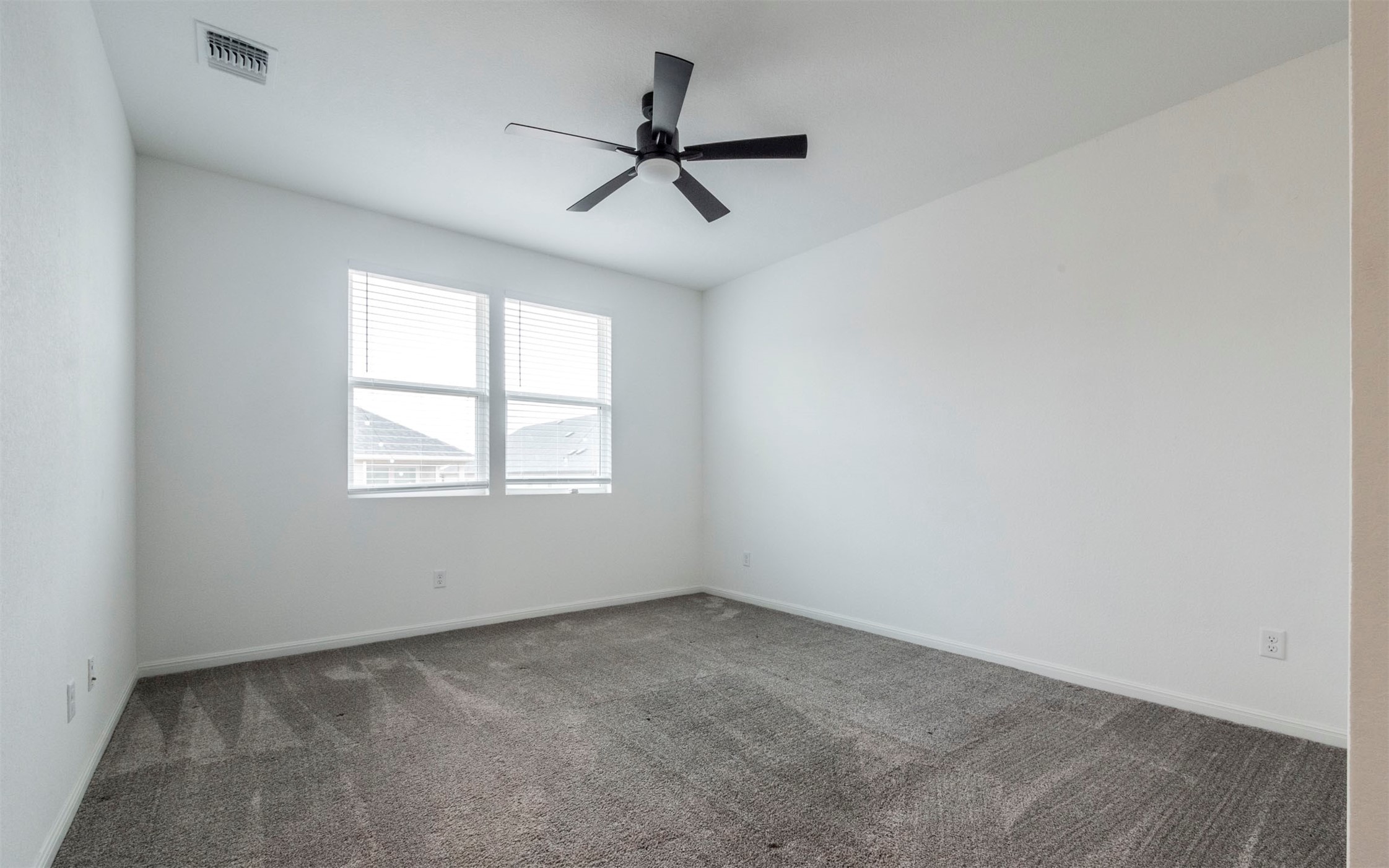 228 Citation Drive Jarrell, TX 76537 - Photo 10 of 30 an empty room with ceiling fan and windows