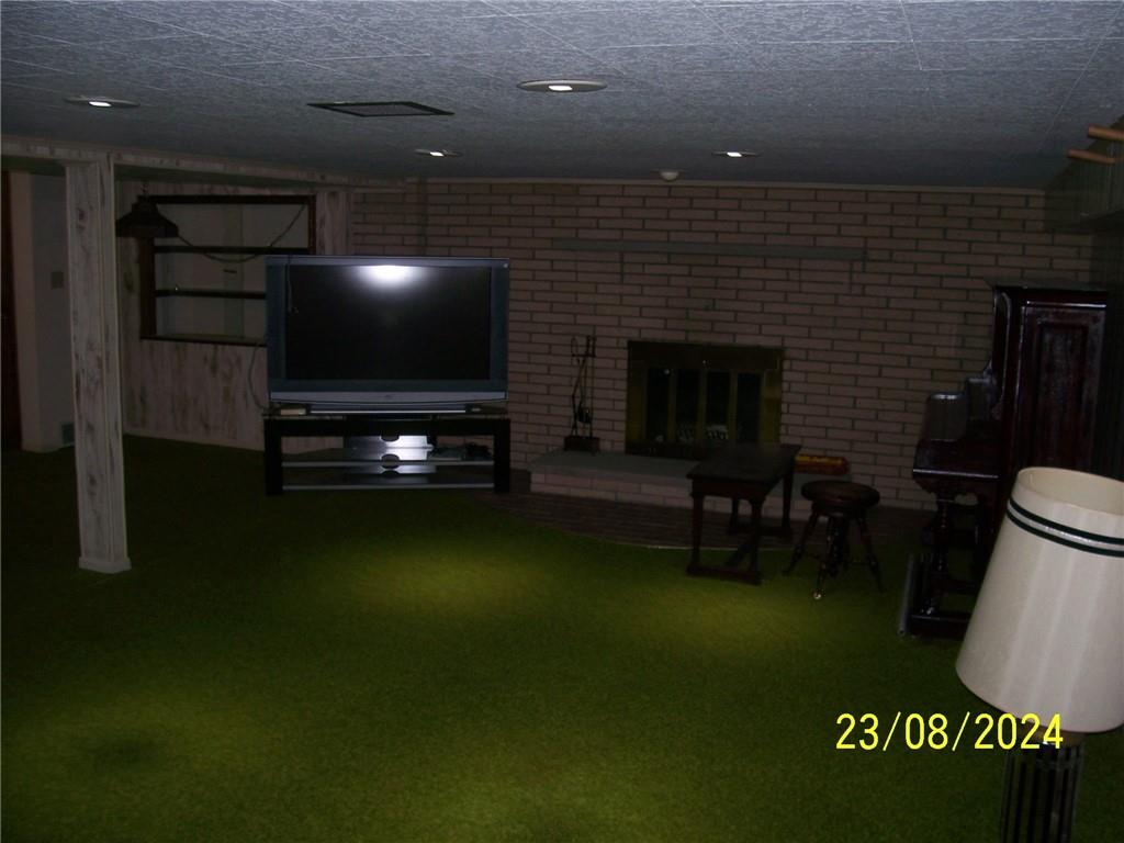748 Narrows Road Connellsville, PA 15425 - Photo 16 of 32 a living room with furniture a flat screen tv and a fireplace