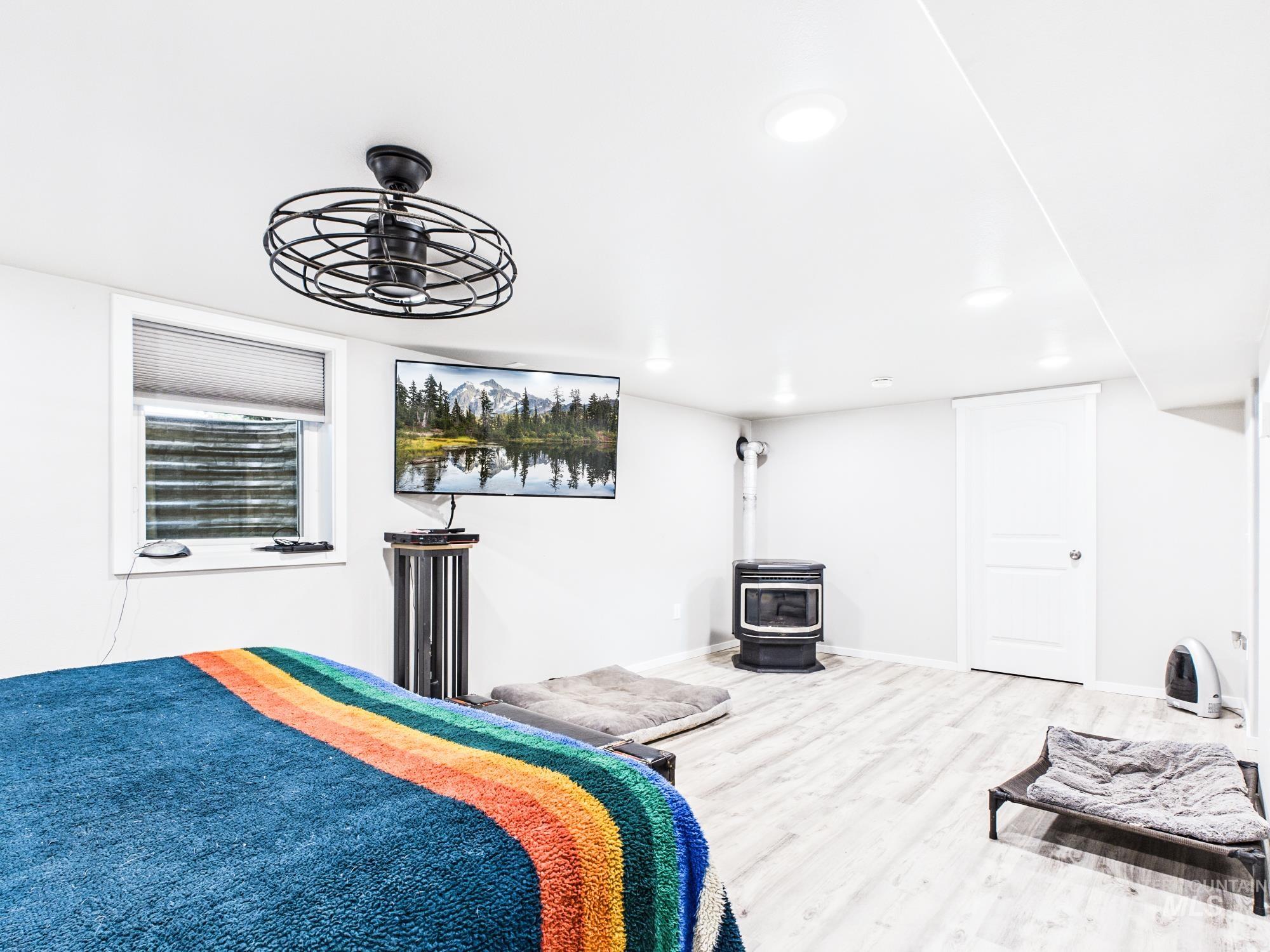 3422 6th Street Lewiston, ID 83501 - Photo 22 of 43 Brightly lit room featuring light wood-finish flooring and a contemporary black ceiling fan