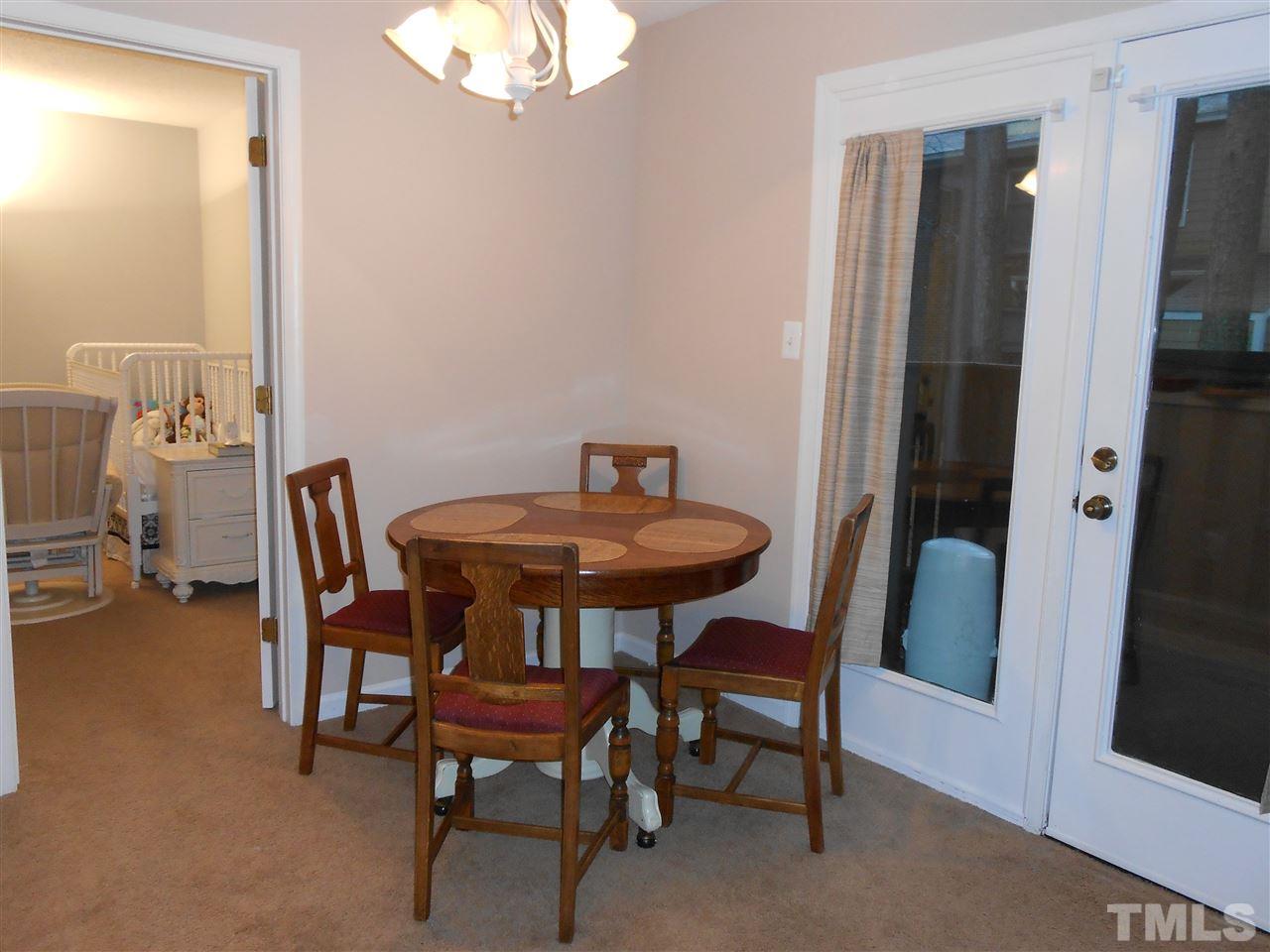 3225 Mill Run, Unit 177 Raleigh, NC 27612 - Photo 5 of 6 a view of a dining room with furniture and wooden floor
