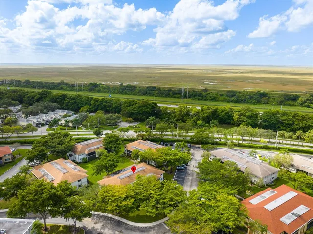 an aerial view of residential houses with outdoor space