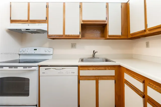 a kitchen with stainless steel appliances white cabinets and a sink