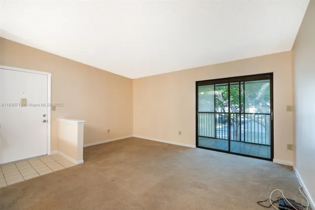 an empty room with sliding glass door
