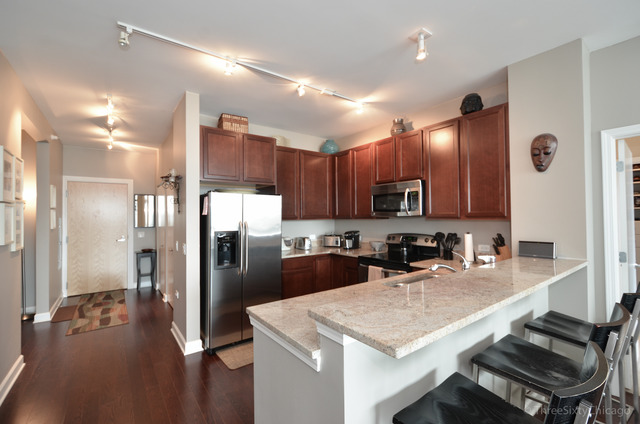 1629 South Prairie Avenue, Unit 809 Chicago, IL 60616 - Photo 5 of 24 a kitchen with refrigerator and cabinets