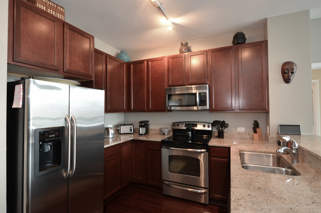 1629 South Prairie Avenue, Unit 809 Chicago, IL 60616 - Photo 6 of 24 a kitchen with stainless steel appliances granite countertop a refrigerator sink and microwave
