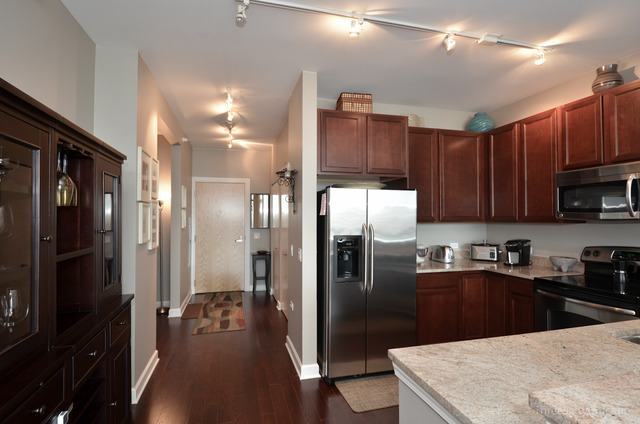 1629 South Prairie Avenue, Unit 809 Chicago, IL 60616 - Photo 7 of 24 a kitchen with stainless steel appliances granite countertop a refrigerator a sink and a stove