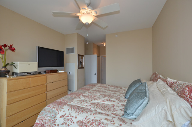 1629 South Prairie Avenue, Unit 809 Chicago, IL 60616 - Photo 10 of 24 a bedroom with a bed and a flat screen tv