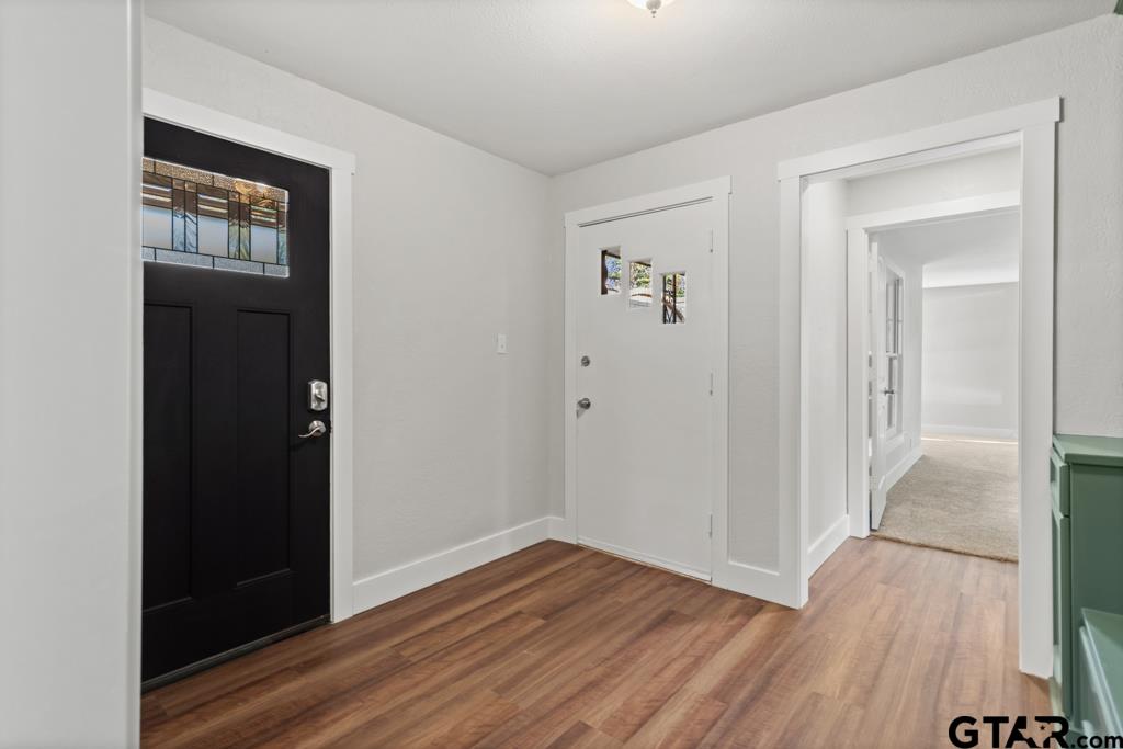 2819 New Copeland Road Tyler, TX 75701 - Photo 5 of 39 wooden floor in a hall with an entryway door