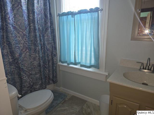210 Main Street Carthage, IL 62321 - Photo 30 of 36 a white toilet sitting next to a bathroom sink