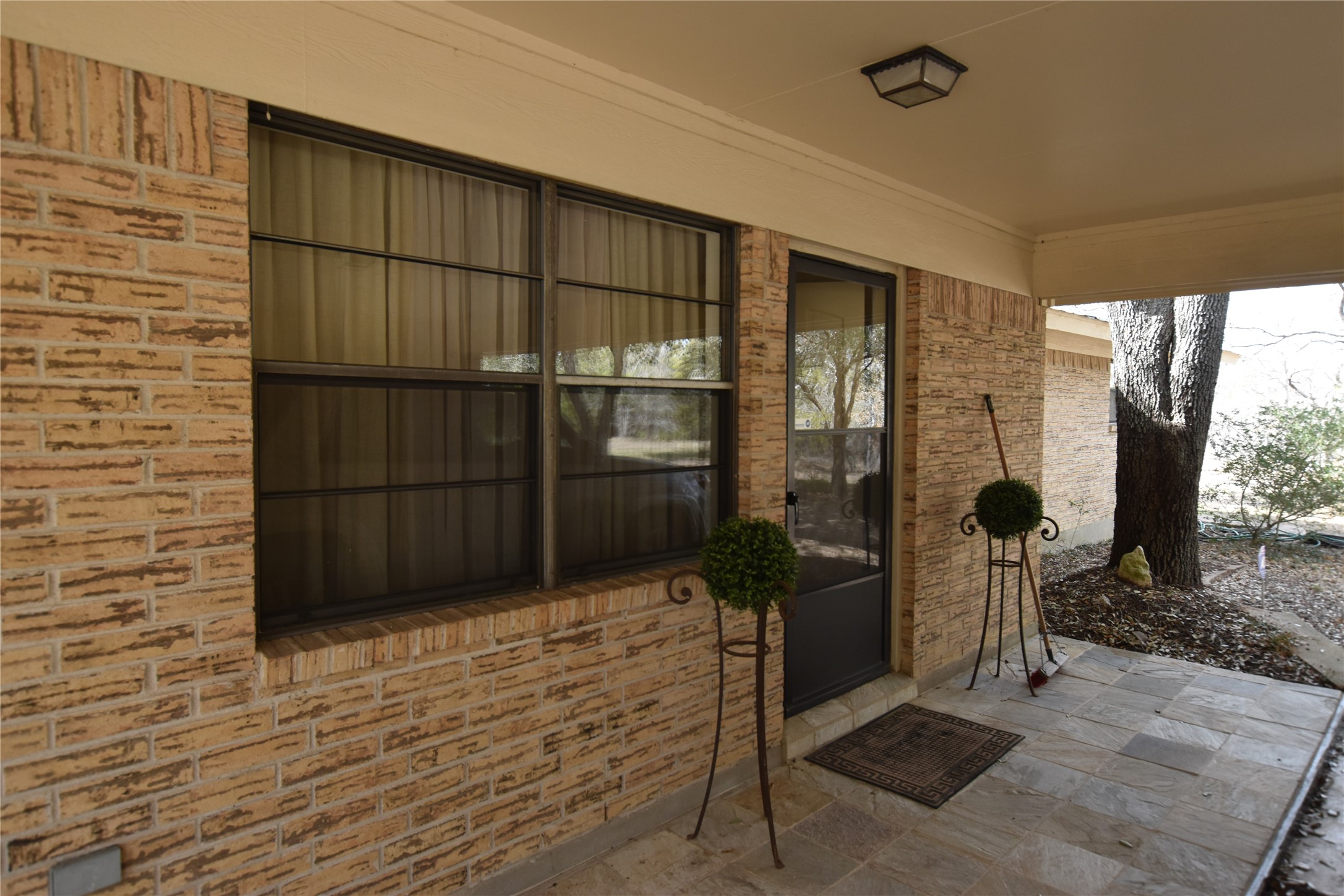 687 Fm 812 Road Red Rock, TX 78662 - Photo 4 of 40 Doorway to property with a patio and brick siding