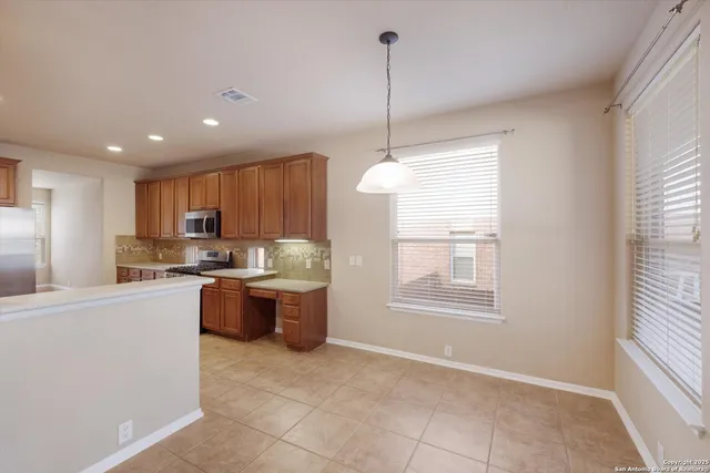 a kitchen with refrigerator and window
