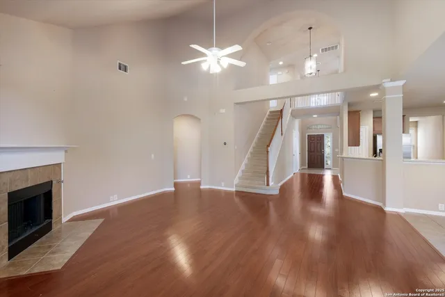 a view of a livingroom with a ceiling fan and wooden floor