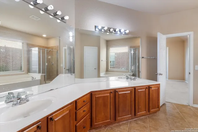 a bathroom with a sink double vanity and a mirror