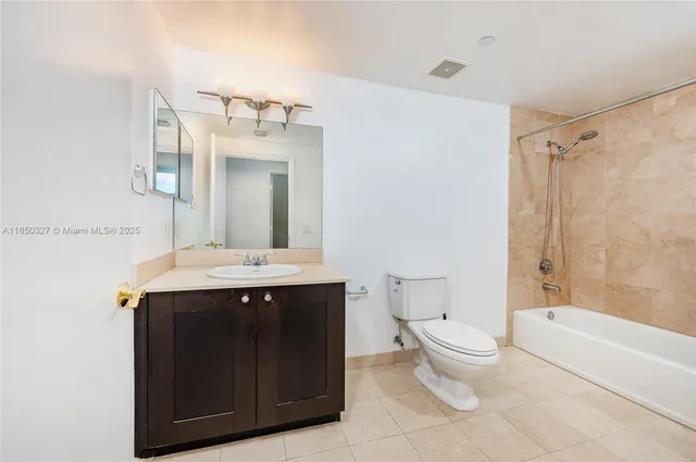 a bathroom with a sink toilet mirror and bathtub