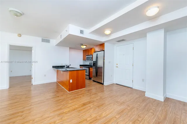 a view of a kitchen with wooden floor
