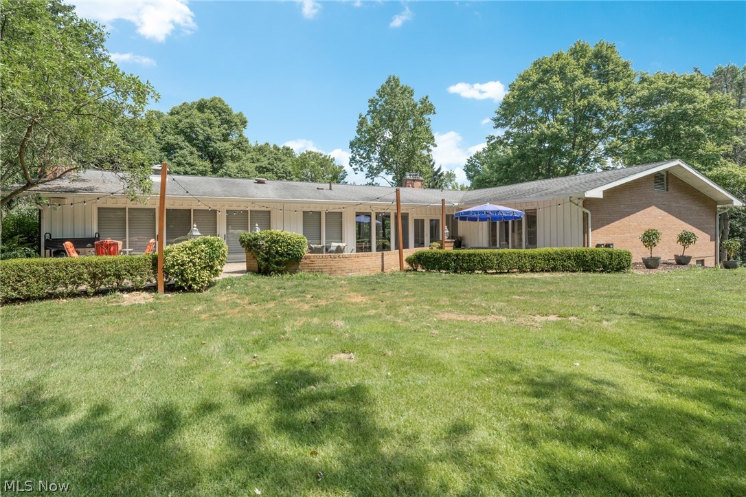 3930 Cardinal Road Akron, OH 44333 - Photo 28 of 34 Patio runs the entire length of the sprawling home. Large backyard outlined by full sized trees creating privacy.